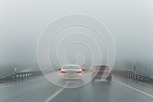 Car overtake rules violation crossing double lane. traffic on foggy misty rainy highway intercity road low poor