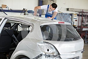 Car painter polishes scratches on car