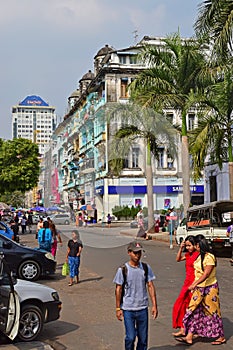 Car parked and colourful shophouses along Sule Pagoda Road in Yangon, Myanmar