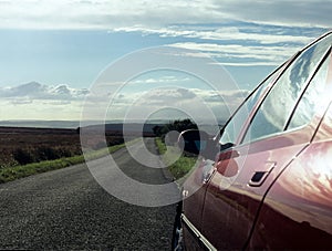 Car parked on country road.