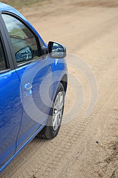 The car is parked on a country road