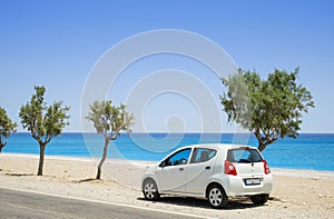 Car parked beside a deserted beach