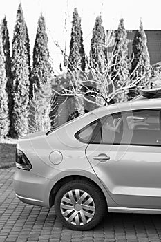 car parked near the garage on the background of garden