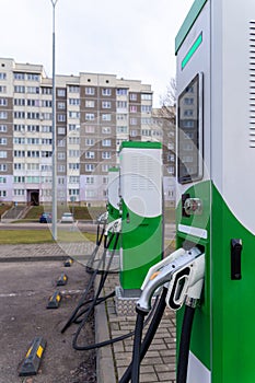 Car parking with charging stations near a multi-storey apartment building