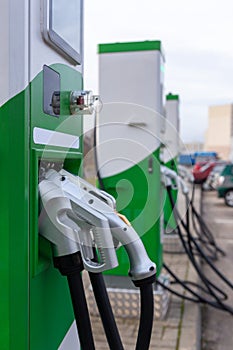 Car parking with charging stations near a multi-storey apartment building