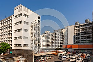 Car parking in large asphalt parking in front of hall building. Outdoor parking