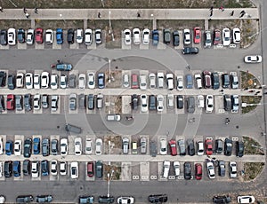Car parking lot with many autos in city, aerial top view