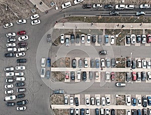 Car parking lot with many autos in city, aerial top view