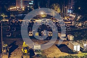 Car parking lot outdoors with auto vehicles at night in city