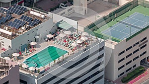 Car parking lot with rooftop swimming pool viewed from above timelapse, Aerial top view. Dubai, UAE