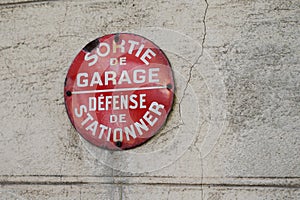 Car parking sign prohibited on building wall means in french defense de stationner sortie de garage means no parking cars can