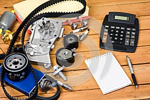 Car parts and the calculator on the wooden table