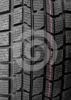 Car parts shop. Tread blocks and sipes on new tire detailed