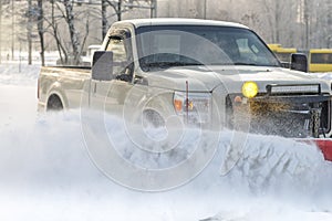 Car pickup cleaned from snow by a snowplough during wintertime photo