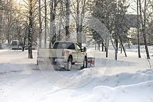 Car pickup cleaned from snow by a snowplough during wintertime photo