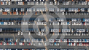 Car plant parking lot with finished multicolored automobiles