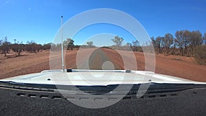 Car point of view driving on a single lane road in the outback of the Northern Territory Australia 01