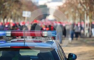 Car of the police during the march with the rioters photo
