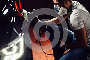 Car polish wax. worker hands holding a polisher