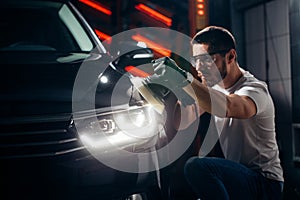 Car polish wax. worker hands holding a polisher