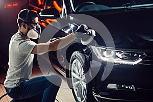 Car polish wax. worker hands holding a polisher photo