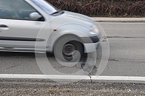 Car and pothole on road