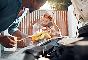 Car problem, child and dad working as a mechanic while teaching daughter to change motor oil and fix vehicle. Black man