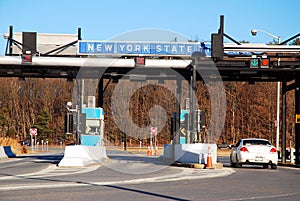 A car pulls up to a toll booth