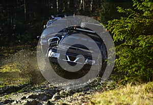 Car racing in autumn forest. Competition, energy and motorsport concept Auto racing on fall nature background. Off road