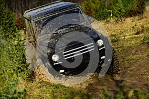 Car racing in autumn forest. Competition, energy and motorsport concept Off road vehicle or SUV overcomes obstacles