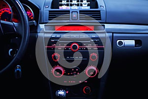 Car radio and air conditioner system. Button on dashboard in modern car panel.