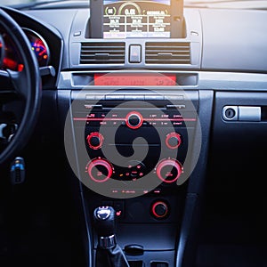 Car radio and air conditioner system. Button on dashboard in modern car panel.