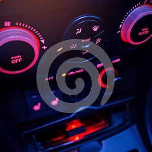 Button on dashboard in modern car panel.