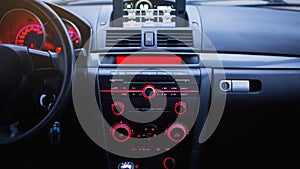 Car radio and air conditioner system. Button on dashboard in modern car panel.
