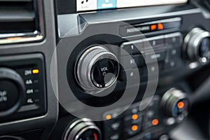 Car radio front volume closeup. Car radio controls. Modern car audio system. Interior Of Luxury Car.