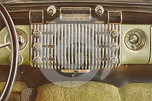 Car radio inside a classic American car with chrome dashboard