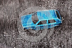 Car during the rain drowns in a huge puddle formed as a result of the flood. Photo effect: water droplets on glass