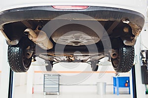 Car raised on car lift in autoservice