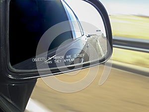 Car rear view mirror warning message in motion