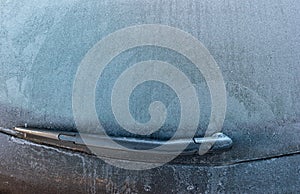 Car rear window covered with ice