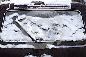car rear window with a janitor in the snow
