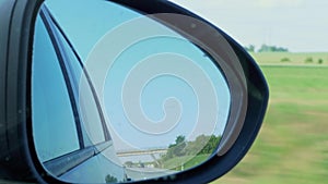 Car reflection in right side rear view mirror during driving