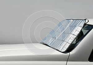 Car with reflective sunshade on front windshield