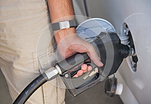 Car refueling at gas station. The driver hand, refuel and pump the car's gasoline with fuel at the petrol station