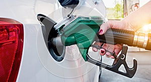 Car refueling on gas station. Woman pumping gasoline oil.