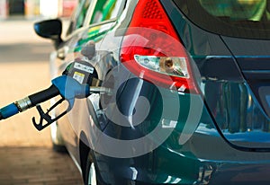 Car refueling on a petrol station close up