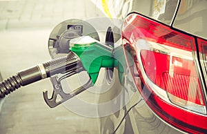 Car refueling at the petrol station. Concept photo for use of fuels gasoline, diesel, ethanol in combustion engines, pollution. photo