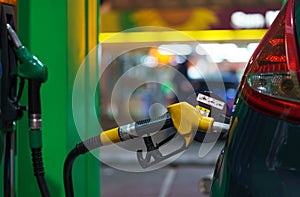 Car refueling on a petrol station at night