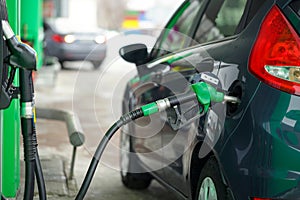 Car refueling on a petrol station in winter