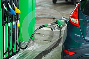 Car refueling on a petrol station in winter close up